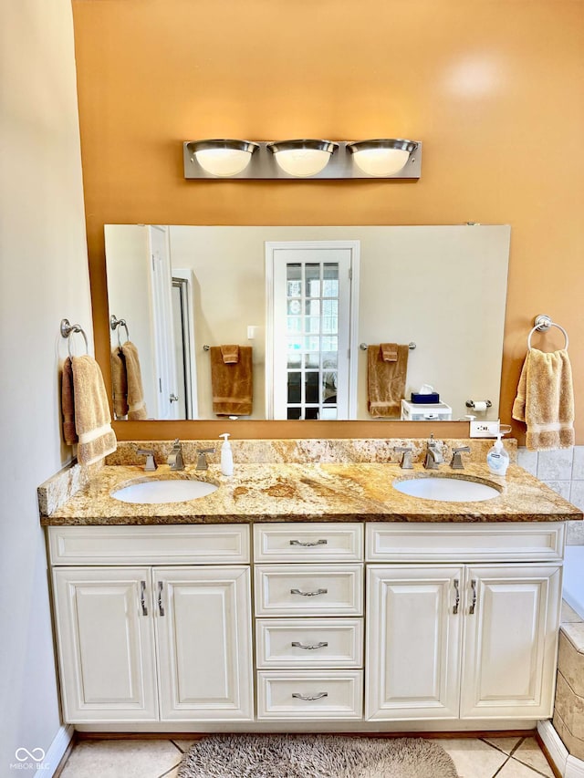 full bath with tile patterned floors, a sink, and double vanity