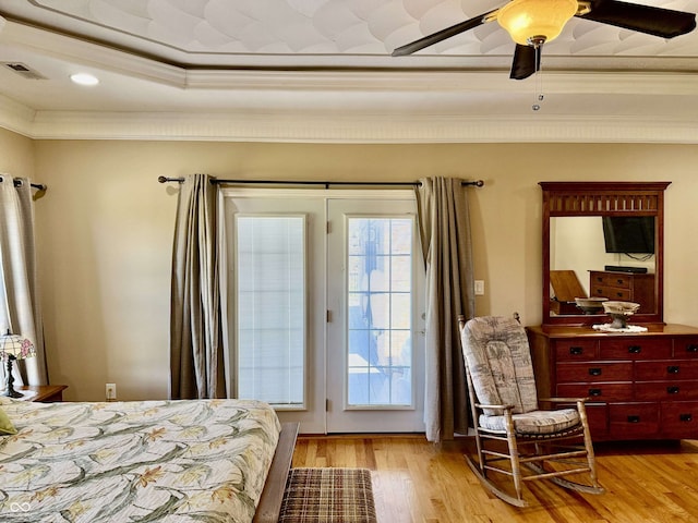 bedroom featuring a ceiling fan, light wood-style floors, ornamental molding, access to exterior, and visible vents