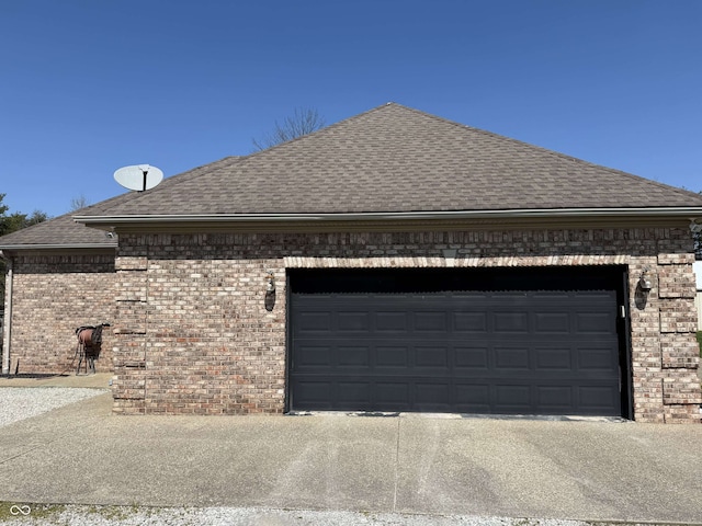 view of home's exterior with an attached garage, brick siding, roof with shingles, and driveway