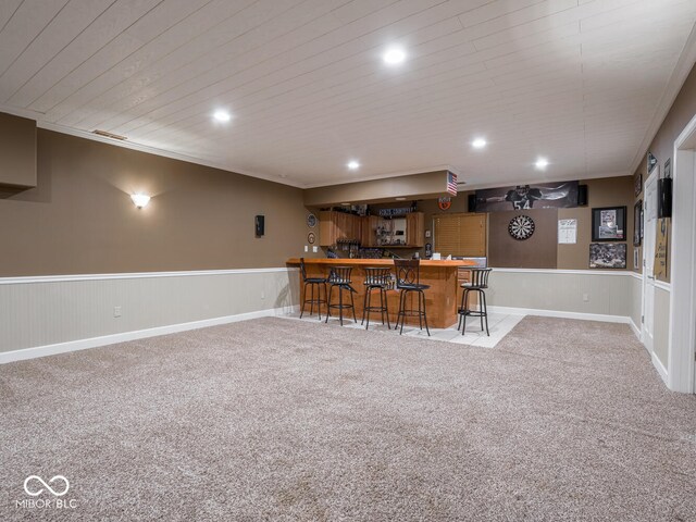 indoor bar featuring a wainscoted wall, carpet floors, recessed lighting, ornamental molding, and wood ceiling