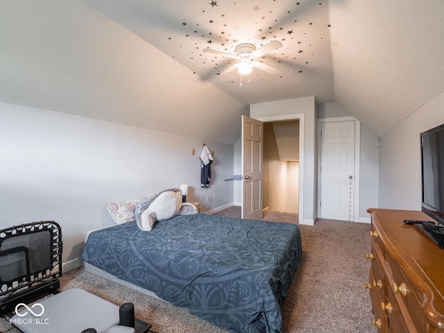 carpeted bedroom featuring vaulted ceiling, baseboards, and a ceiling fan