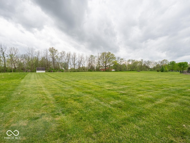view of grassy yard with a view of countryside