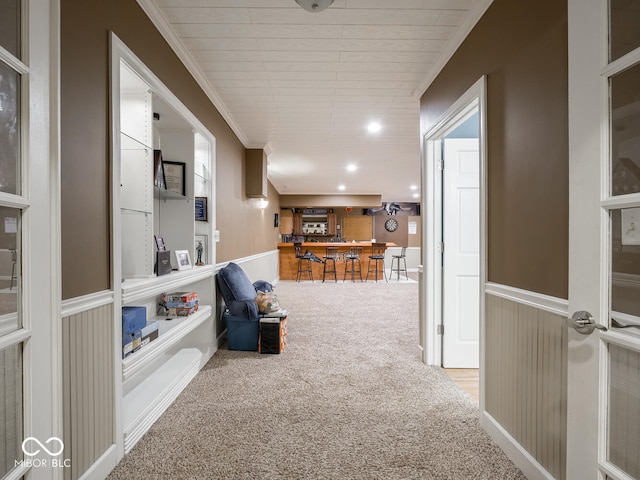 corridor featuring wainscoting, carpet flooring, crown molding, and recessed lighting