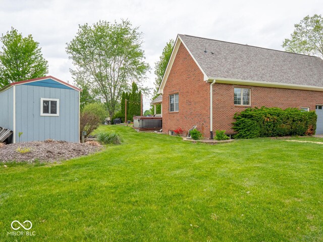 view of grassy yard featuring a hot tub