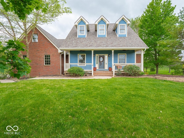 cape cod home with a front yard, roof with shingles, and a porch
