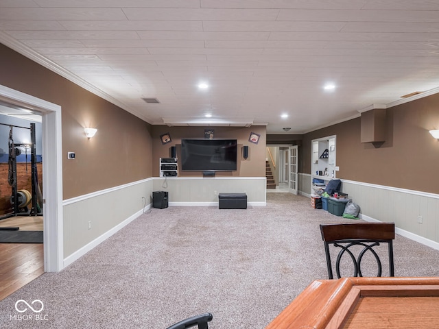carpeted living area featuring wainscoting, ornamental molding, and recessed lighting