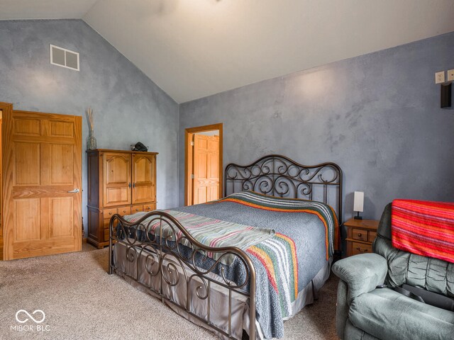carpeted bedroom with lofted ceiling