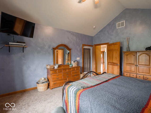 carpeted bedroom with high vaulted ceiling