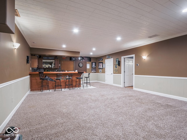 indoor bar with a wainscoted wall, crown molding, carpet, recessed lighting, and wooden ceiling