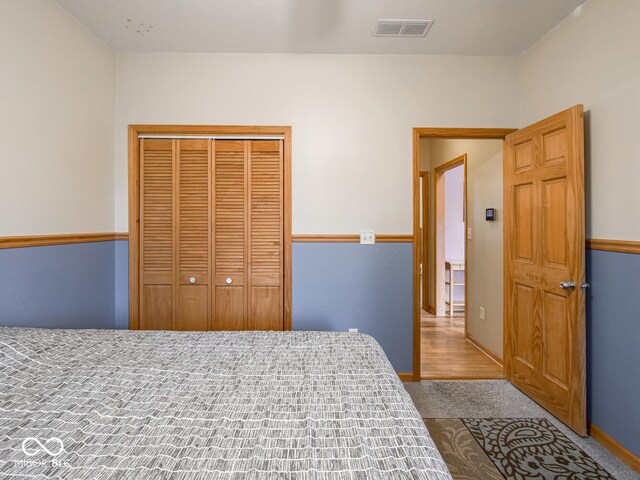bedroom featuring a closet, carpet, and baseboards