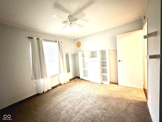 unfurnished bedroom with a ceiling fan and carpet