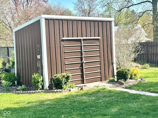 view of outbuilding featuring an outdoor structure and fence
