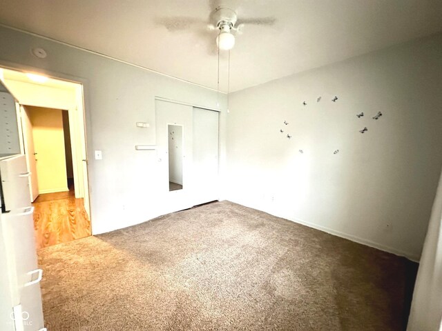 spare room featuring a ceiling fan and light colored carpet