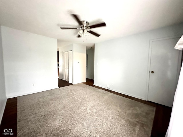 empty room featuring ceiling fan and baseboards