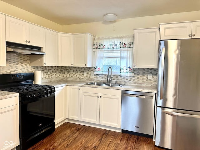 kitchen featuring white cabinetry, a sink, stainless steel appliances, light countertops, and under cabinet range hood