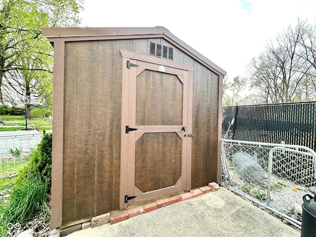 view of shed with fence