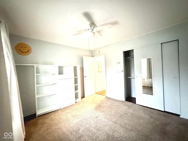unfurnished bedroom featuring ceiling fan, a closet, and carpet
