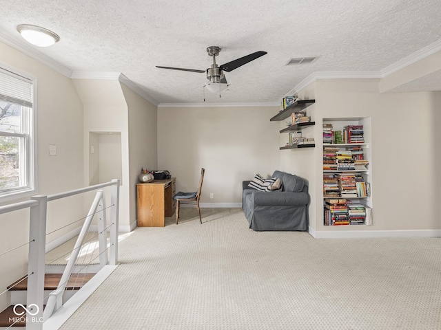 living area with carpet floors, a ceiling fan, crown molding, and a textured ceiling