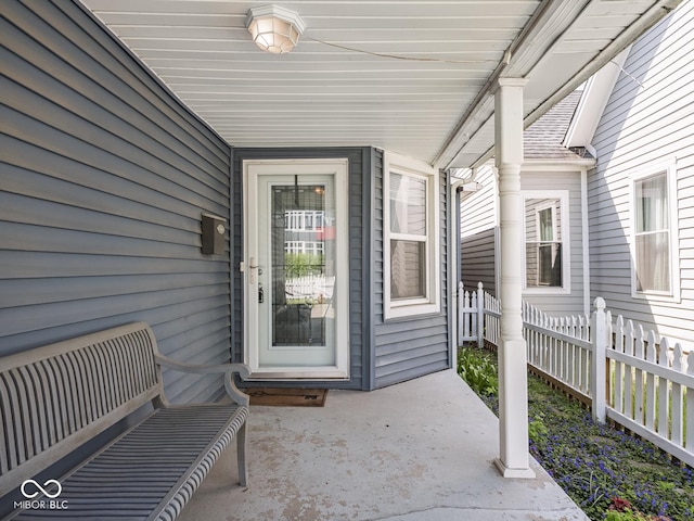 property entrance with a patio and fence