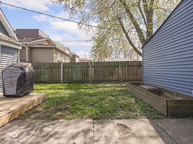 view of yard featuring fence and a vegetable garden