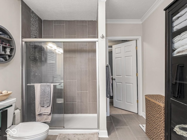 full bathroom with crown molding, toilet, a textured ceiling, and a stall shower