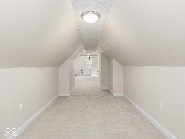 bonus room featuring carpet floors, baseboards, and vaulted ceiling