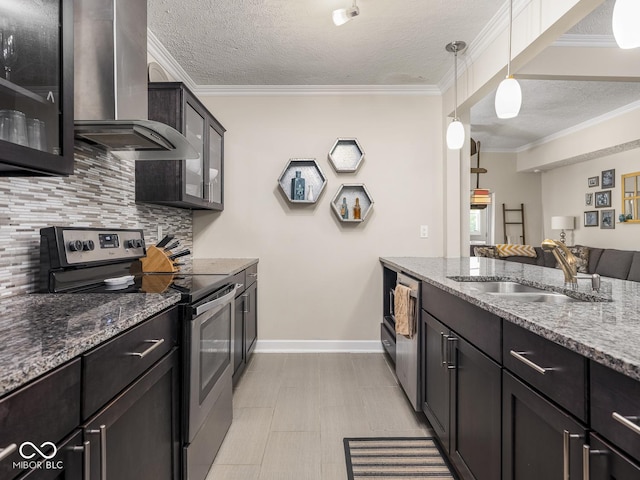 kitchen featuring wall chimney range hood, crown molding, a sink, a textured ceiling, and stainless steel appliances