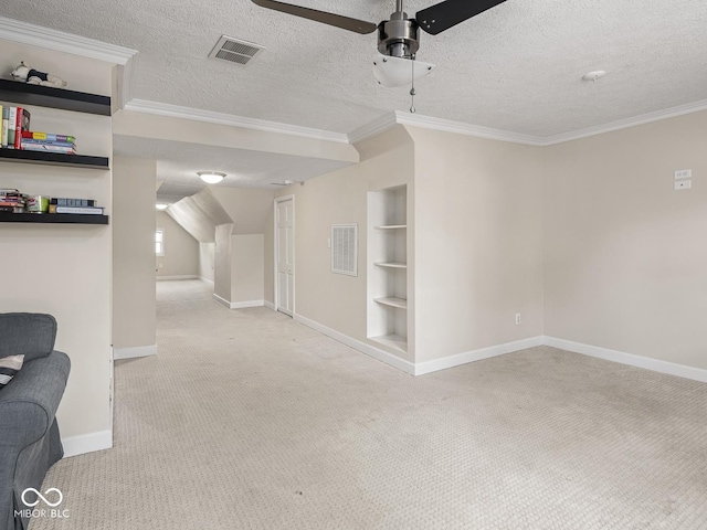 interior space featuring baseboards, visible vents, light carpet, and built in shelves