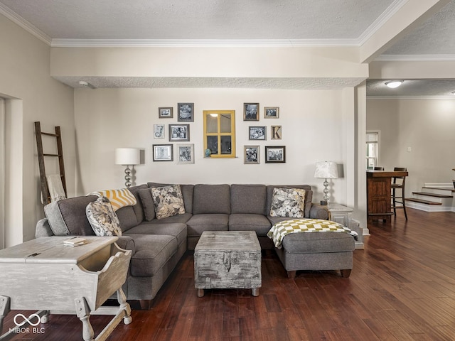 living area with wood-type flooring, a textured ceiling, and ornamental molding