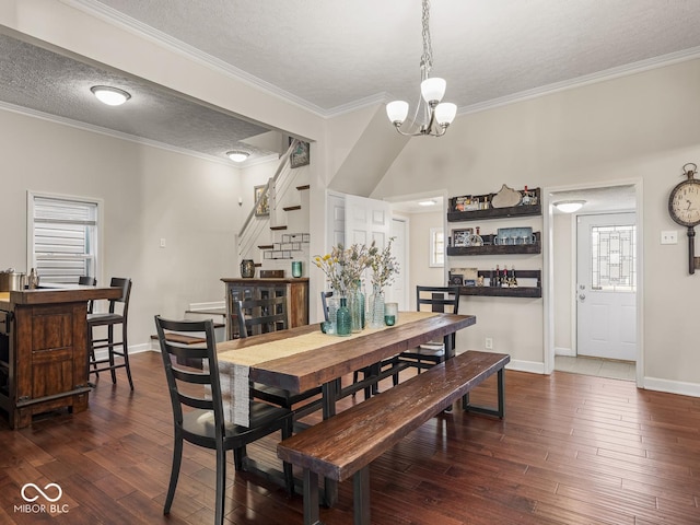 dining space with an inviting chandelier, baseboards, a textured ceiling, and dark wood-type flooring