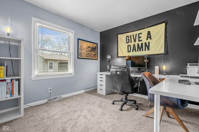 carpeted office space with baseboards and visible vents