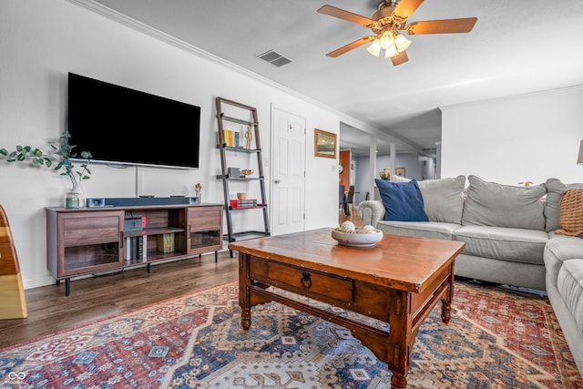 living room featuring ceiling fan, crown molding, wood finished floors, and visible vents