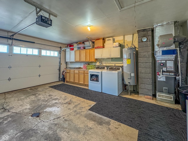 garage featuring water heater, heating unit, a garage door opener, and separate washer and dryer