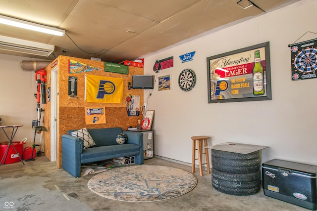 living area with concrete flooring