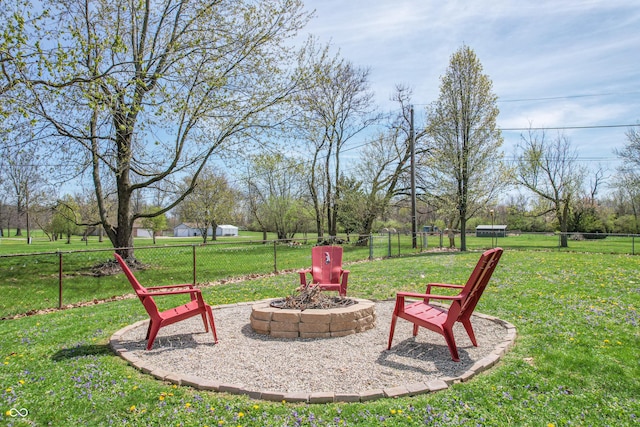 view of yard featuring fence and a fire pit