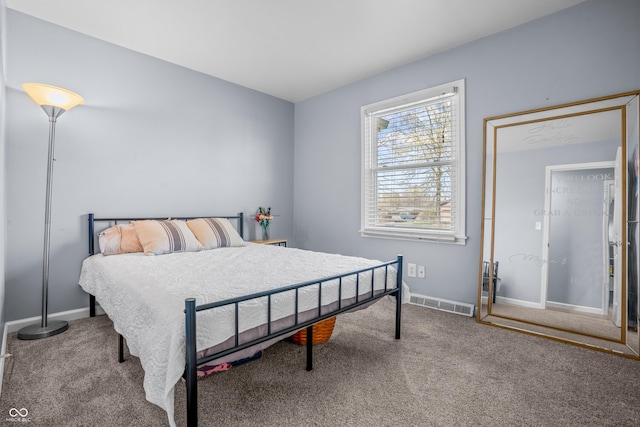bedroom with baseboards, visible vents, and carpet
