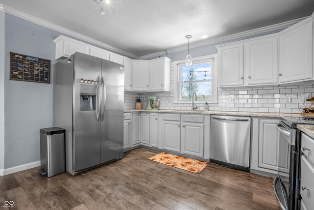 kitchen with tasteful backsplash, a sink, appliances with stainless steel finishes, white cabinetry, and ornamental molding