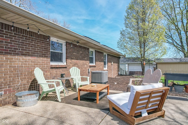 view of patio / terrace with an outdoor structure and central AC unit