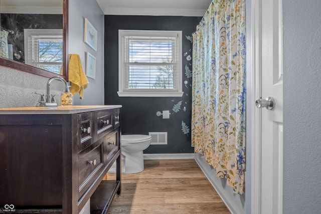 full bathroom with toilet, wood finished floors, visible vents, and plenty of natural light