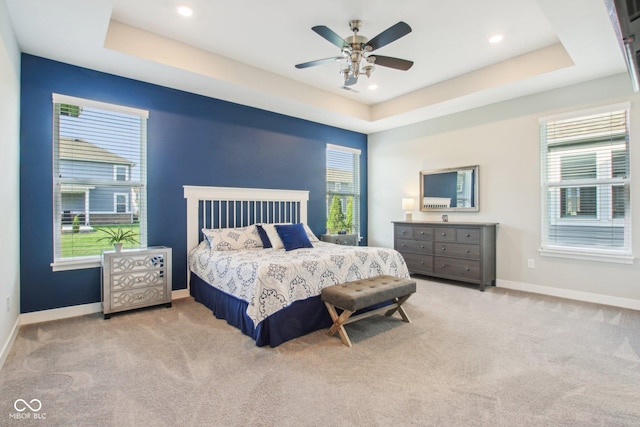 carpeted bedroom with recessed lighting, a raised ceiling, baseboards, and ceiling fan