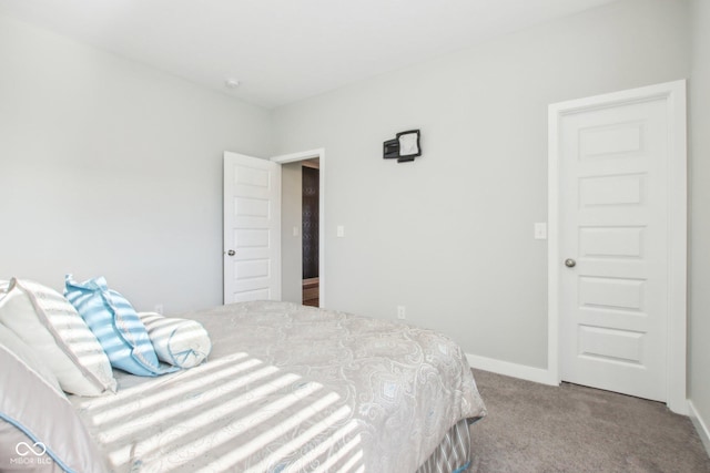 bedroom featuring carpet floors and baseboards