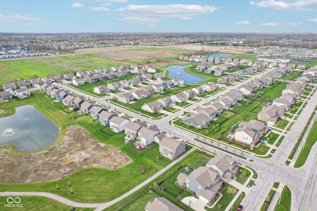 drone / aerial view featuring a residential view and a water view