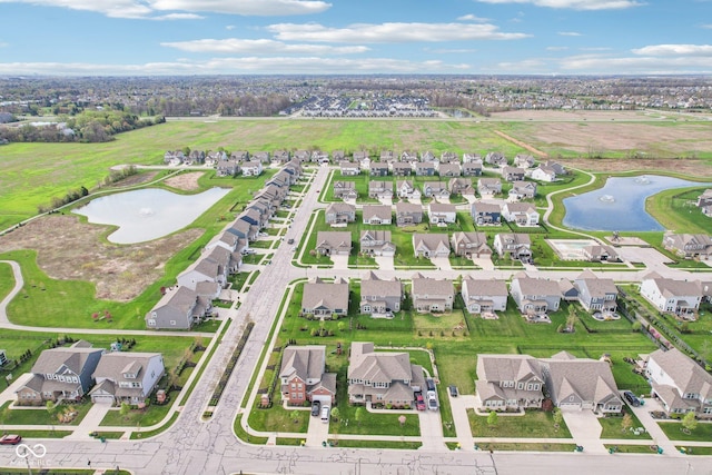 birds eye view of property featuring a water view and a residential view