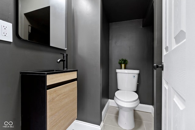 2005 Carrollton Ave, Indianapolis, IN 46202 - bathroom featuring toilet, tile patterned floors, baseboards, and vanity