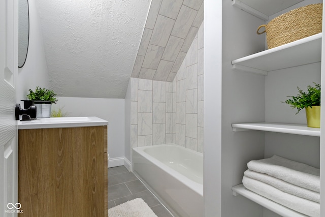 2005 Carrollton Ave, Indianapolis, IN 46202 - bathroom with tile patterned flooring, lofted ceiling, vanity, and bathtub / shower combination