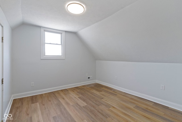 2005 Carrollton Ave, Indianapolis, IN 46202 - additional living space featuring light wood finished floors, lofted ceiling, and baseboards