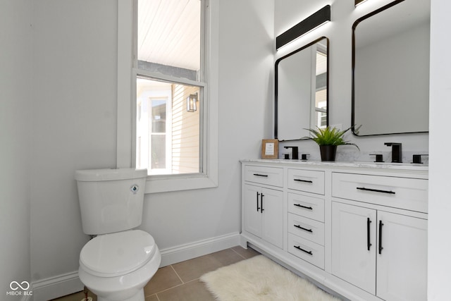 2005 Carrollton Ave, Indianapolis, IN 46202 - bathroom featuring healthy amount of natural light, tile patterned flooring, baseboards, and toilet
