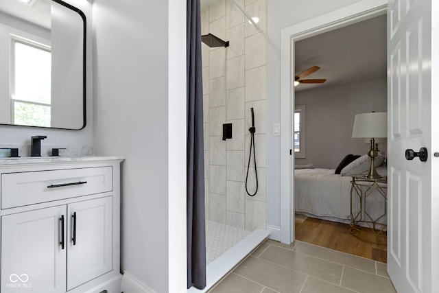 2005 Carrollton Ave, Indianapolis, IN 46202 - bathroom featuring healthy amount of natural light, tile patterned floors, a ceiling fan, and a tile shower