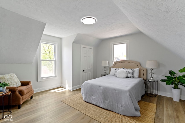 2005 Carrollton Ave, Indianapolis, IN 46202 - bedroom with a textured ceiling, lofted ceiling, baseboards, and wood finished floors