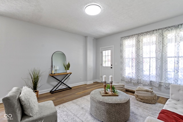 2005 Carrollton Ave, Indianapolis, IN 46202 - living area featuring a textured ceiling, wood finished floors, and baseboards